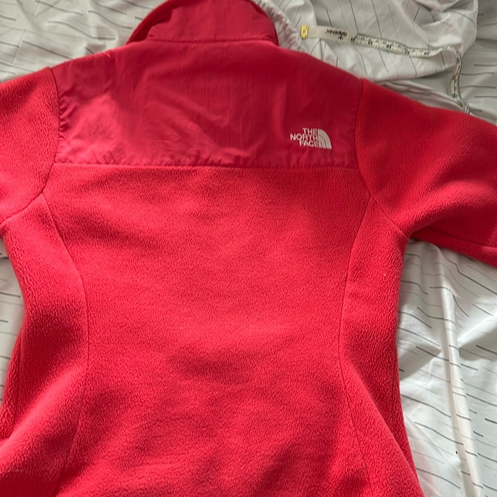 Pretty coral color . Looks somewhat red . North face jacket